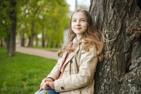 Photo for Adorable young girl having fun on beautiful spring day. Teenager portrait in spring park. Teen girl outdoors. - Royalty Free Image