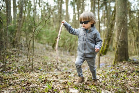 Photo for Adorable toddler boy having fun during a hike in the woods on beautiful sunny spring day. Active family leisure with kids. Child exploring nature. - Royalty Free Image
