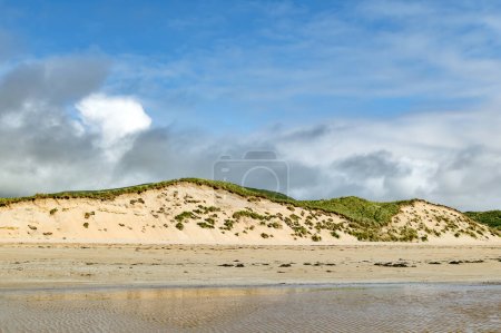 Photo for Five Finger Strand, one of the most famous beaches in Inishowen known for its pristine sand and surrounding rocky coastline with some of the highest sand dunes in Europe, county Donegal, Ireland. - Royalty Free Image
