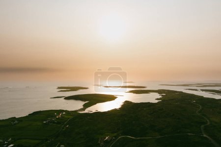 Spectacular sunset view of Ardmore and Turbot islands from famous scenic Sky Road, 15km looped drive starting in Clifden with numerous brilliant viewing points, Wild Atlantic Way, Connemara, Ireland.