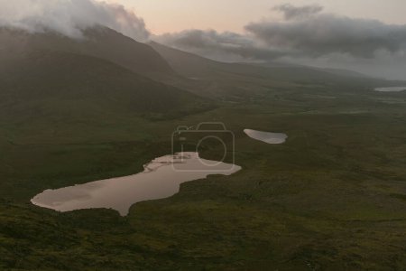 Photo for Conor Pass, one of the highest Irish mountain passes served by an asphalted road, located on the south-western end of the Dingle Peninsula, County Kerry, Ireland - Royalty Free Image