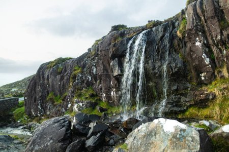 Foto de Pequeña cascada en el paso de Conor, uno de los pasos de montaña más altos de Irlanda servida por una carretera asfaltada, situada en el extremo suroeste de la península de Dingle, Condado de Kerry, Irlanda - Imagen libre de derechos