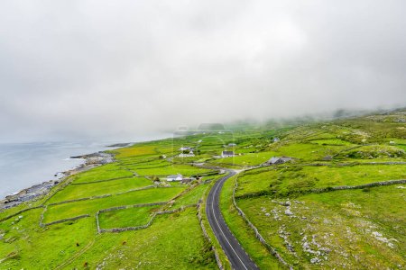 Spectacular misty aerial landscape in the Burren region of County Clare, Ireland. Exposed karst limestone bedrock at the Burren National Park. Rough Irish nature.