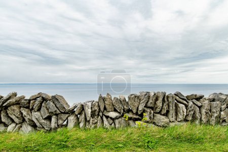 Famous Irish dry-stone wall, built with a variety of stones to separate and protect crop fields as well as create separated fields for livestock grazing.