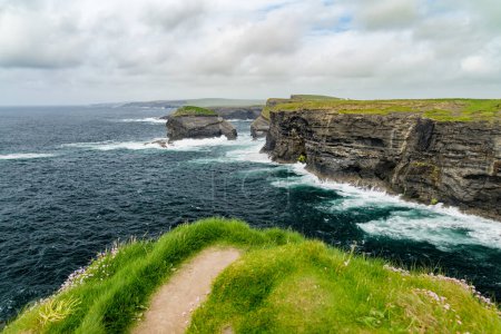 Photo for Spectacular Kilkee Cliffs, situated at the Loop Head Peninsula, remote and wild stretch of stunning coastline, Wild Atlantic Way Discovery Point, county Clare, Ireland. - Royalty Free Image