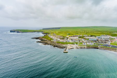 Photo for Aerial view of Kilkee, small coastal town, popular as a seaside resort, located in horseshoe bay and protected from the Atlantic Ocean by the Duggerna Reef, county Clare, Ireland. - Royalty Free Image