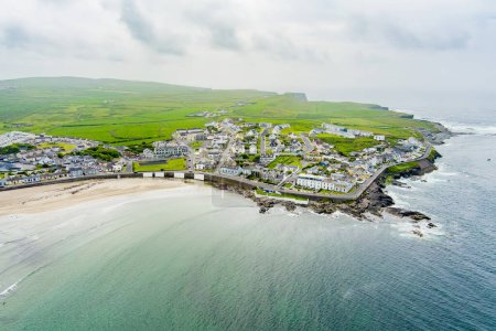 Aerial view of Kilkee, small coastal town, popular as a seaside resort, located in horseshoe bay and protected from the Atlantic Ocean by the Duggerna Reef, county Clare, Ireland.