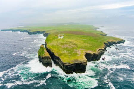 Aerial view of the Loop Head Lighthouse, located south-east of Kilkee, on the northern Dingle Peninsula, on the cliffs of Loop Head in County Clare, Ireland.