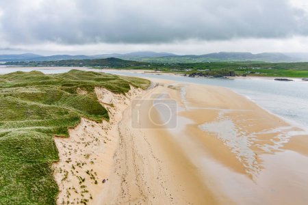 Photo for Five Finger Strand, one of the most famous beaches in Inishowen known for its pristine sand and surrounding rocky coastline with some of the highest sand dunes in Europe, county Donegal, Ireland. - Royalty Free Image