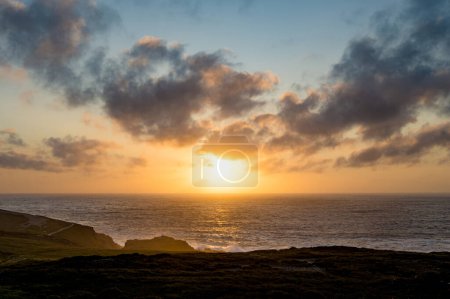 Photo for Sun setting at Malin Head, Ireland's northernmost point, Wild Atlantic Way, spectacular coastal route. Wonders of nature. Numerous Discovery Points. Co. Donegal - Royalty Free Image