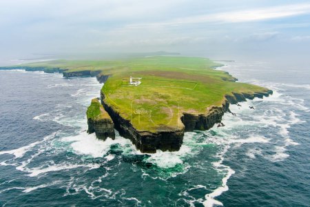 Photo for Aerial view of the Loop Head Lighthouse, located south-east of Kilkee, on the northern Dingle Peninsula, on the cliffs of Loop Head in County Clare, Ireland. - Royalty Free Image