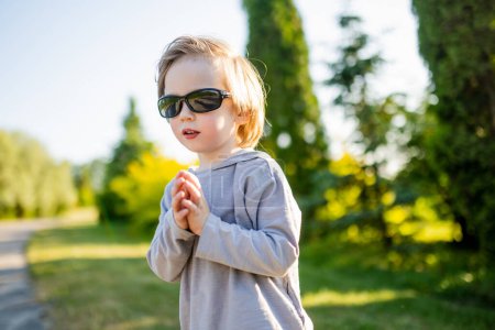 Photo for Adorable little boy having fun outdoors on sunny summer day. Kid running outdoors. Child exploring nature. Summer activities for small kids. - Royalty Free Image