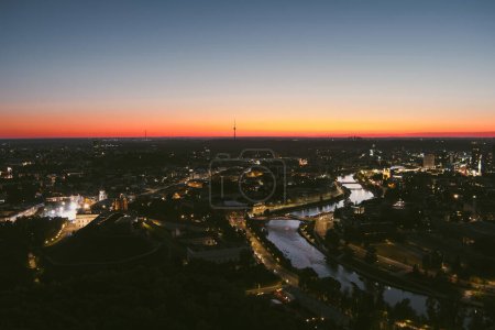 Photo for Scenic aerial view of Vilnius Old Town and Neris river at nightfall. Sunset landscape. Night view of Vilnius, Lithuania. - Royalty Free Image