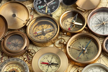 Photo for Many different compasses on an old map - Royalty Free Image