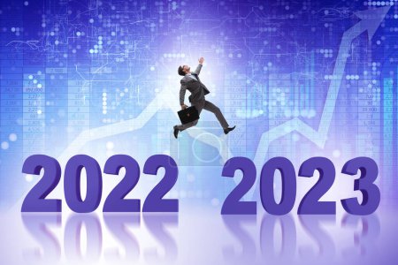 Photo for Businessman jumping from year 2022 to 2023 - Royalty Free Image