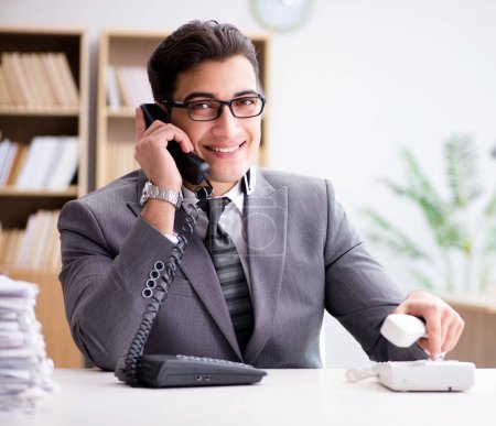 Photo for The helpdesk operator talking on phone in office - Royalty Free Image