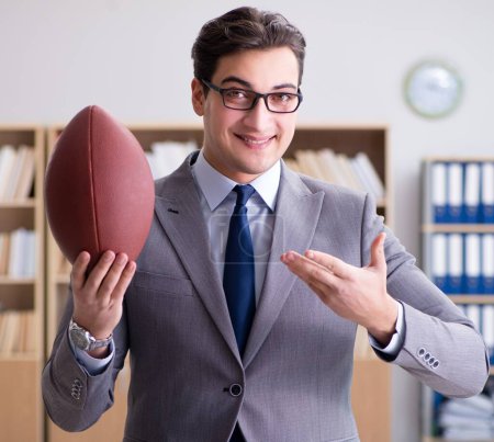 Photo for The businessman with american football in office - Royalty Free Image