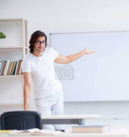 Photo for The young male student in front of whiteboard - Royalty Free Image