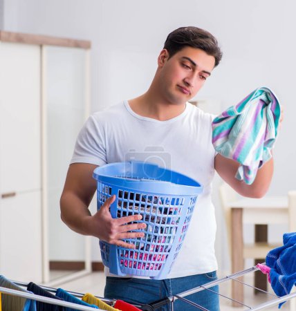 Photo for The man doing laundry at home - Royalty Free Image