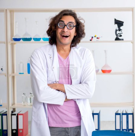 Photo for The funny male chemist working in the lab - Royalty Free Image