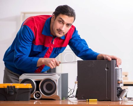 Photo for The young engineer repairing musical hi-fi system - Royalty Free Image