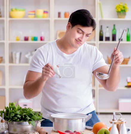 Photo for The young male cook working in the kitchen - Royalty Free Image