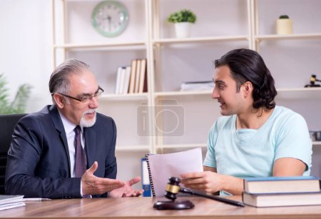 Photo for The young man visiting experienced male lawyer - Royalty Free Image