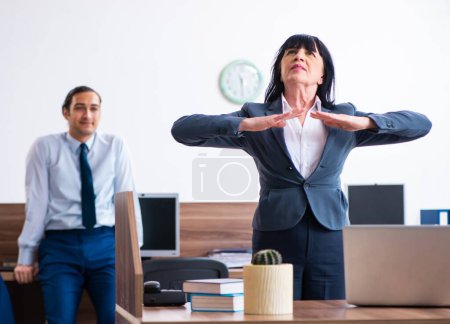 Photo for The two employees doing sport exercises in the office - Royalty Free Image