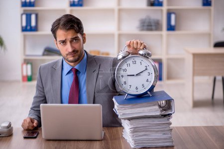 Photo for Young businessman employee in time management concept - Royalty Free Image