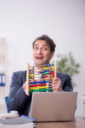 Photo for Young bookkeeper in budget planning concept holding abacus - Royalty Free Image