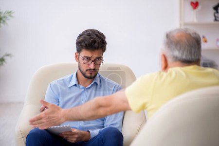 Photo for Old man visiting young psychotherapist - Royalty Free Image