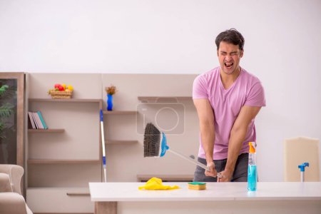 Photo for Young contractor cleaning the house - Royalty Free Image