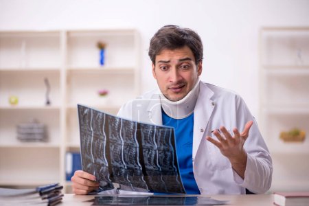 Photo for Young doctor holding neck brace - Royalty Free Image