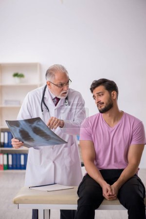 Photo for Young patient visiting old doctor radiologist - Royalty Free Image