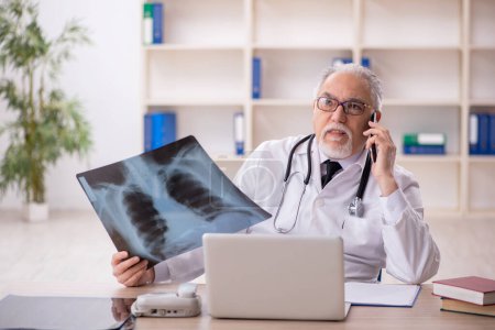 Photo for Aged male doctor radiologist working in the clinic - Royalty Free Image