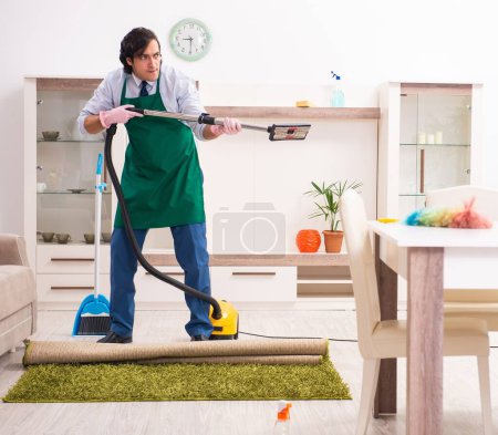 Foto de El joven empresario limpiando la casa - Imagen libre de derechos