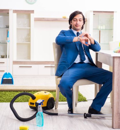 Photo for The young businessman cleaning the house - Royalty Free Image