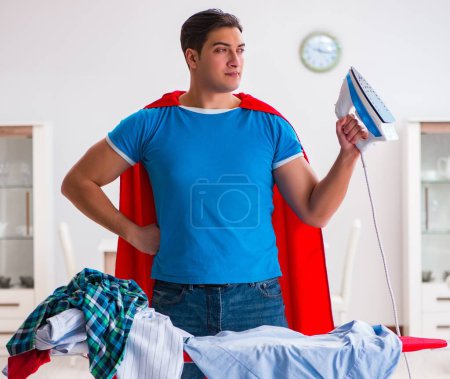 Photo for The super hero man husband ironing at home - Royalty Free Image