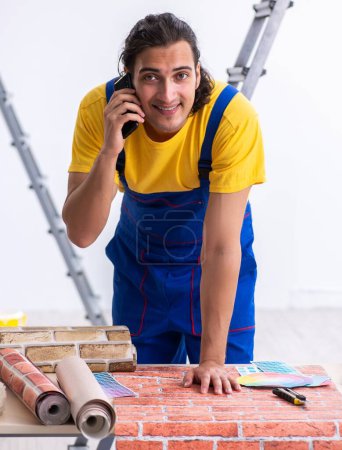 Foto de El joven contratista haciendo la renovación en casa - Imagen libre de derechos