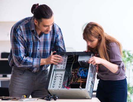 Photo for The two repairmen repairing desktop computer - Royalty Free Image