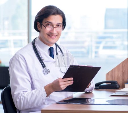 Photo for The young handsome doctor working in the clinic - Royalty Free Image