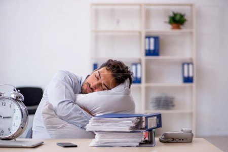 Photo for Young businessman employee in oversleeping concept - Royalty Free Image