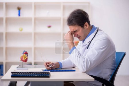 Photo for Young doctor being tired after night shift - Royalty Free Image