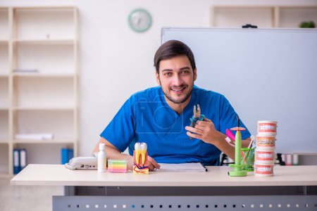 Photo for Young dentist lecturer in front of whiteboard - Royalty Free Image