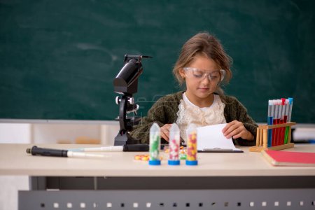 Téléchargez les photos : Jeune fille chimiste dans la salle de classe - en image libre de droit
