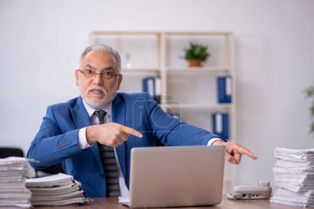 Foto de Viejo empleado de negocios y demasiado trabajo en la oficina - Imagen libre de derechos