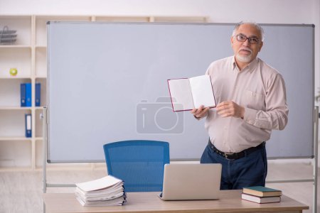 Photo for Old teacher in front of whiteboard - Royalty Free Image