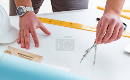 Photo for The male engineer working on drawings and blueprints - Royalty Free Image