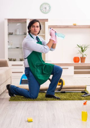 Photo for The young businessman cleaning the house - Royalty Free Image