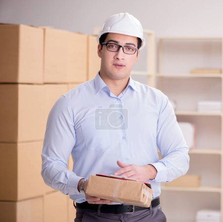 Photo for The young worker in the postal office dealing with parcels - Royalty Free Image